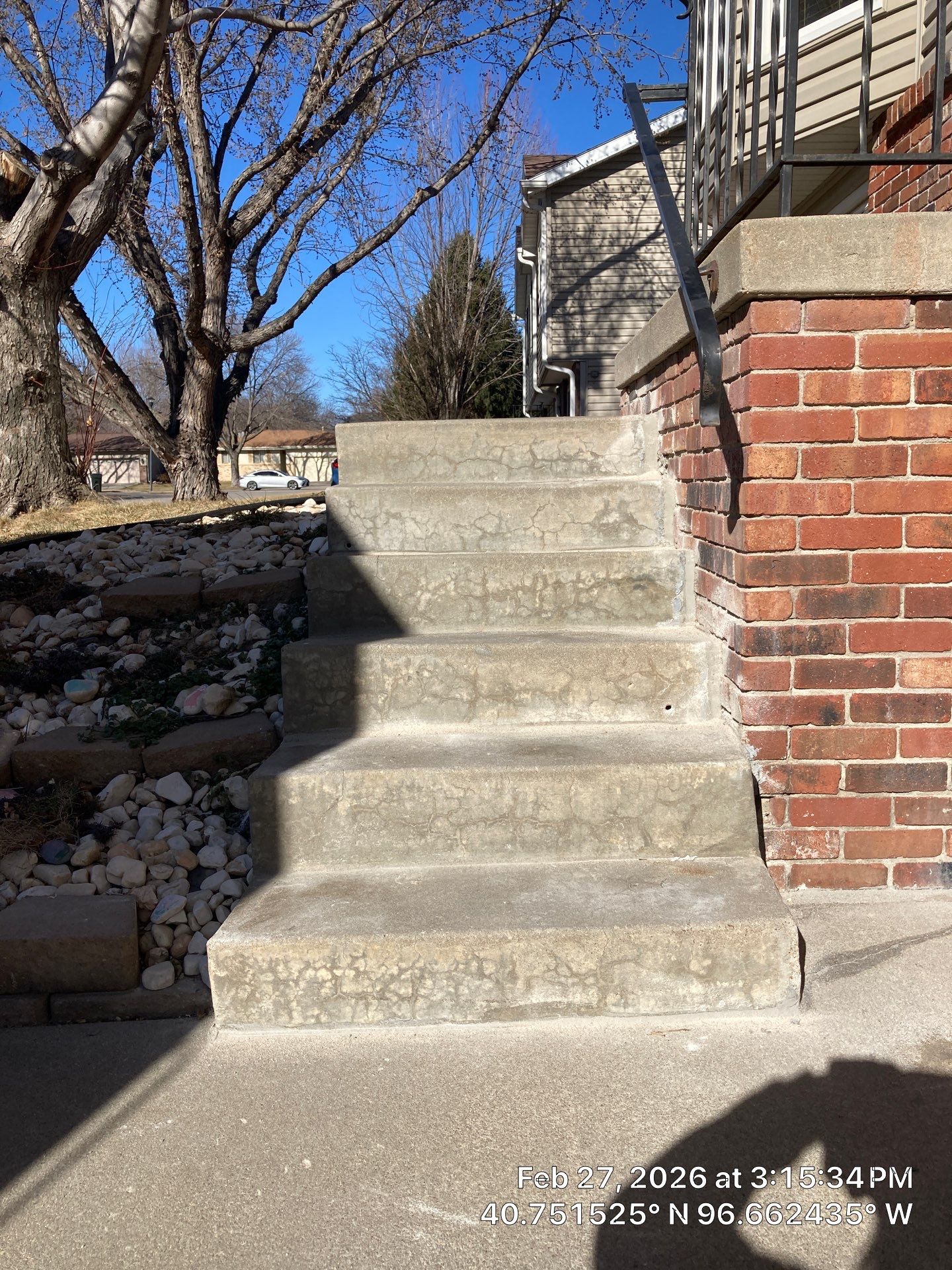 Early warning signs of pitting, flaking, and staining on exterior concrete on a Midwest home