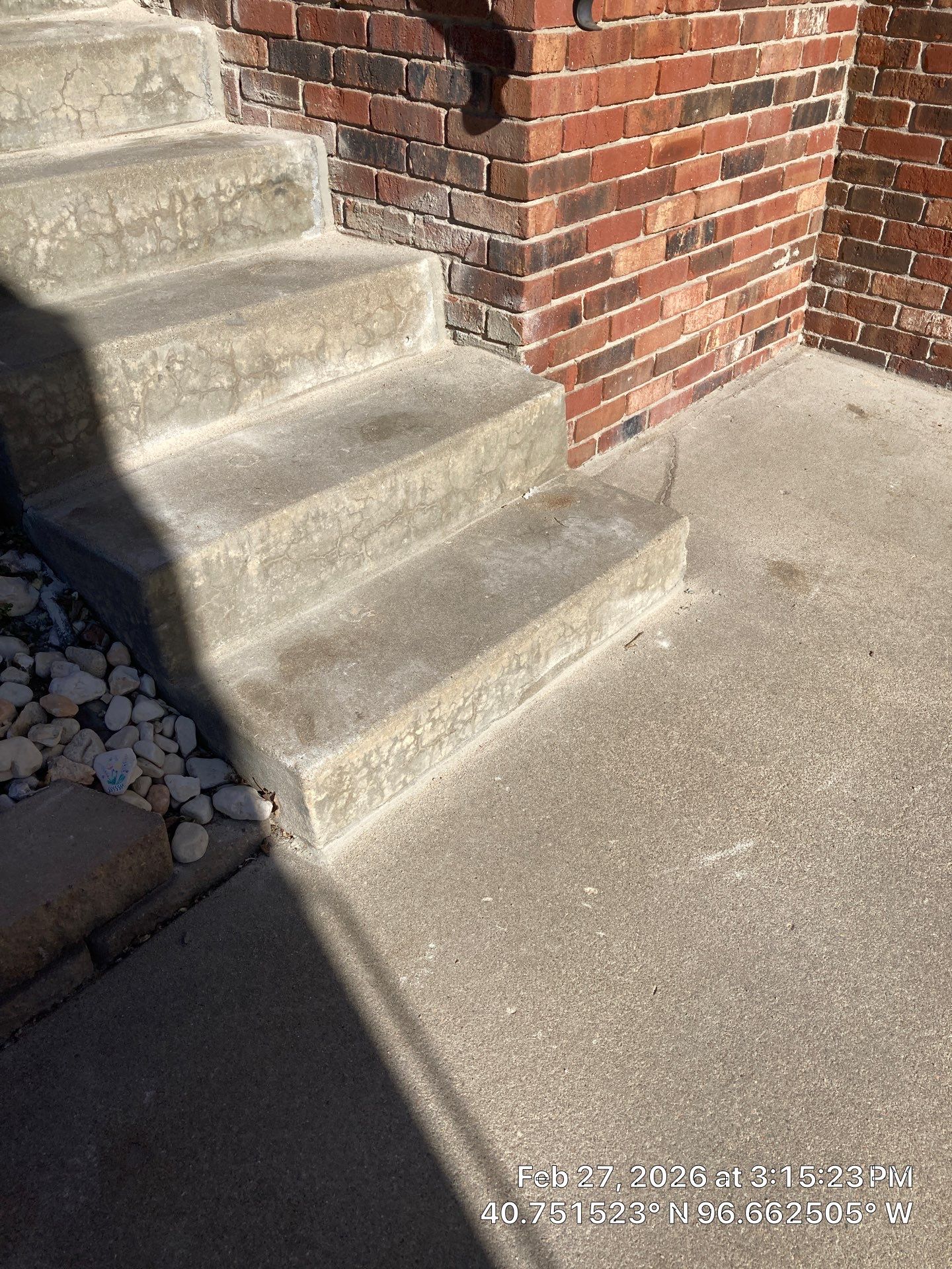 Early warning signs of pitting, flaking, and staining on exterior concrete on a Midwest home