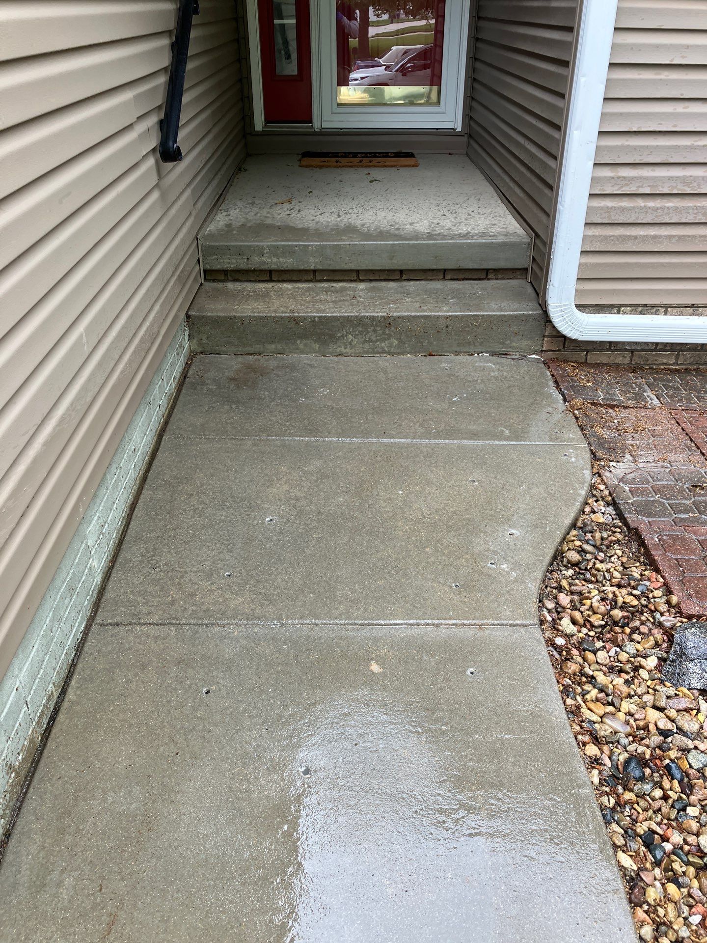 Epp Foundation Repair crew preparing concrete walkway and steps for leveling with drilled holes in Lincoln, Nebraska.