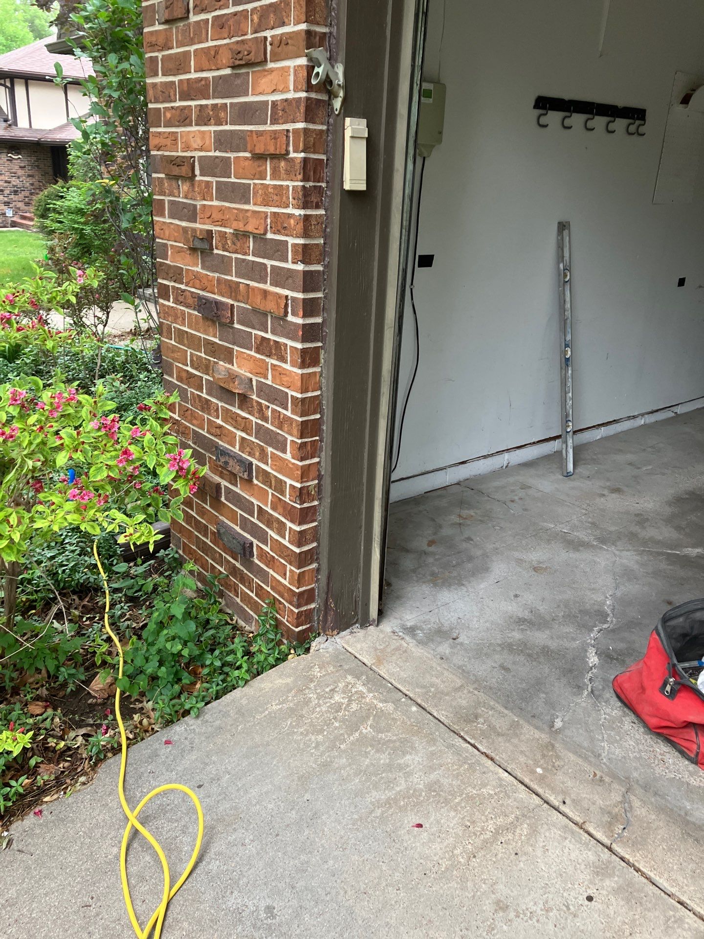 Epp Foundation Repair inspecting cracked concrete on a residential driveway and garage entrance.