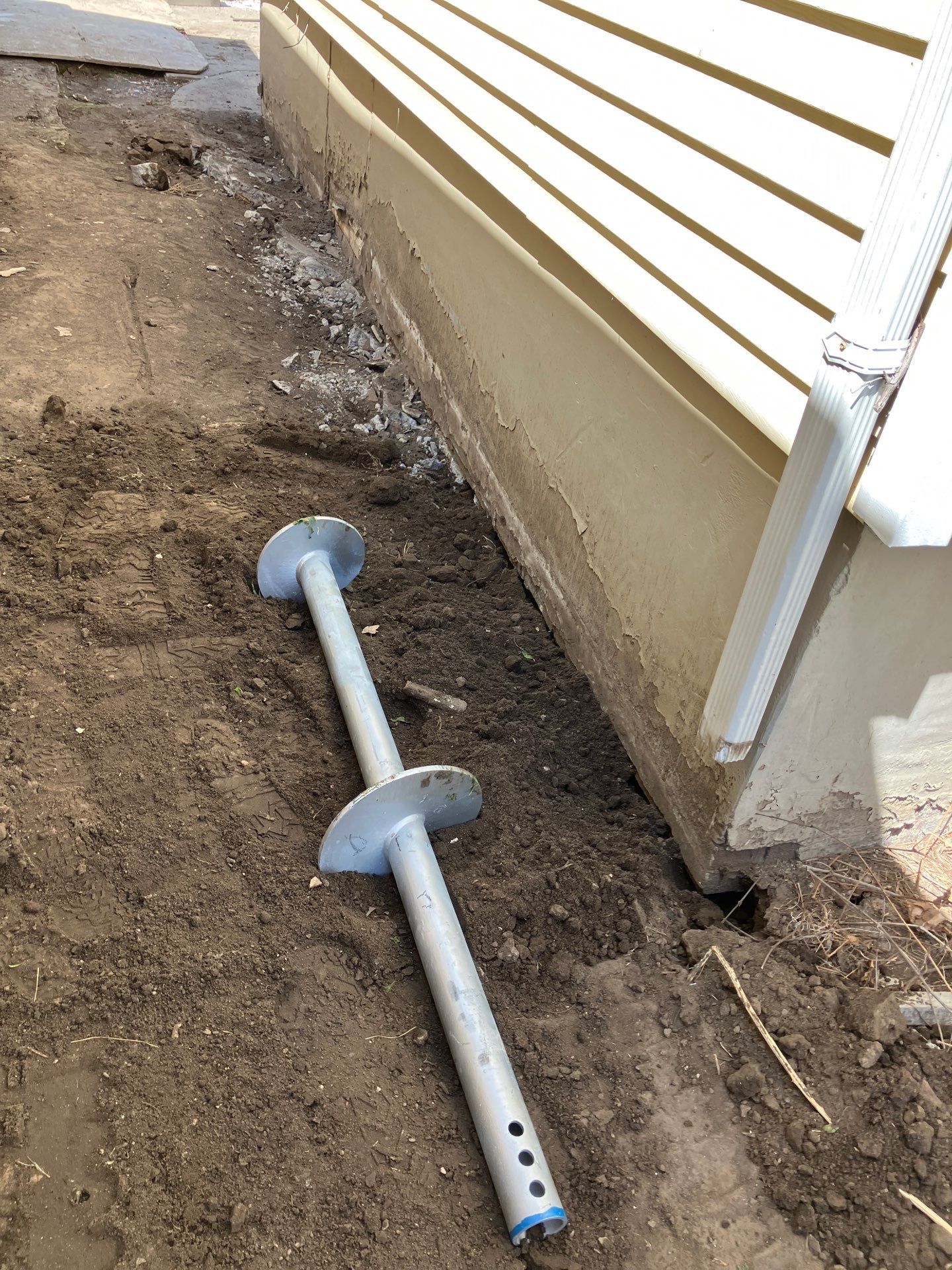 Epp Foundation Repair installing foundation support piers for structural repair in Des Moines, Iowa.